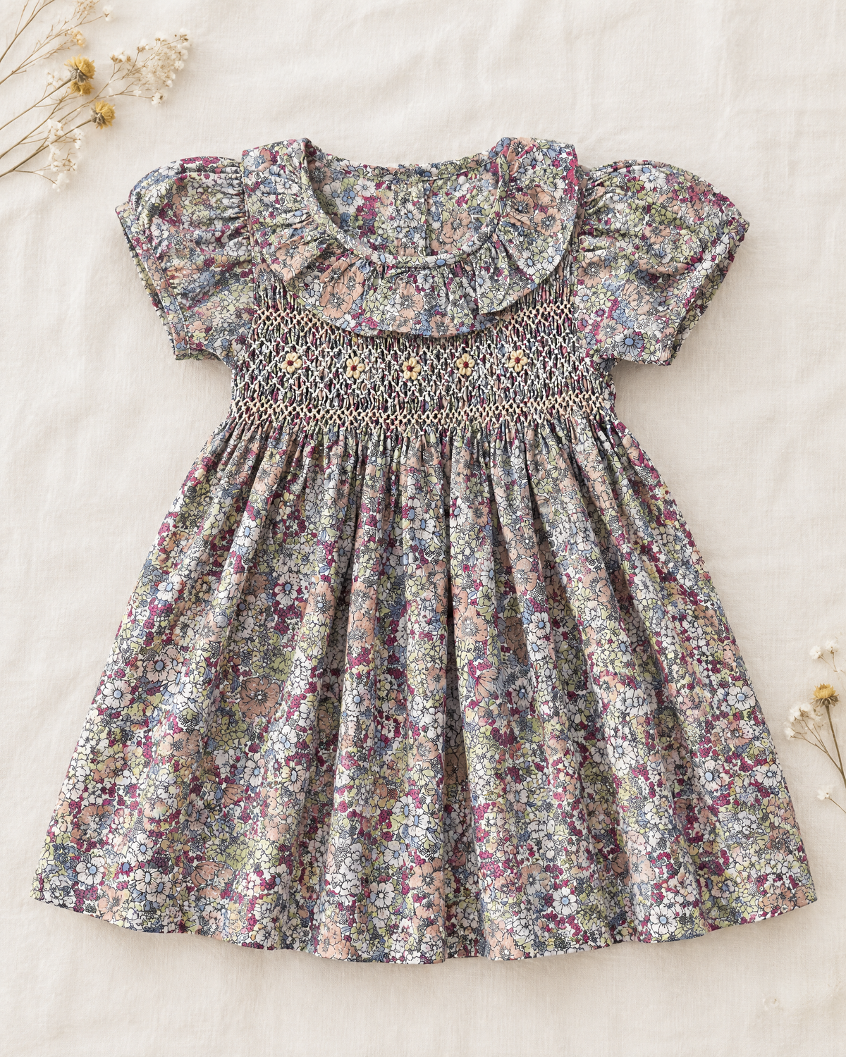 Floral cotton dress with hand smocking and ruffled collar